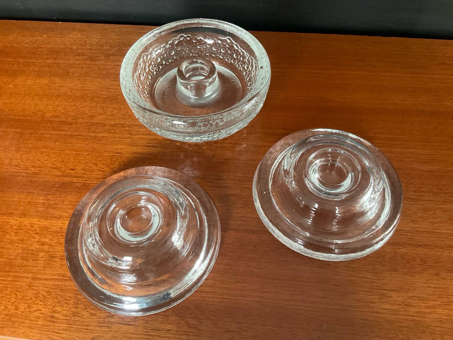 Set of three round thick moulded glass candle holders