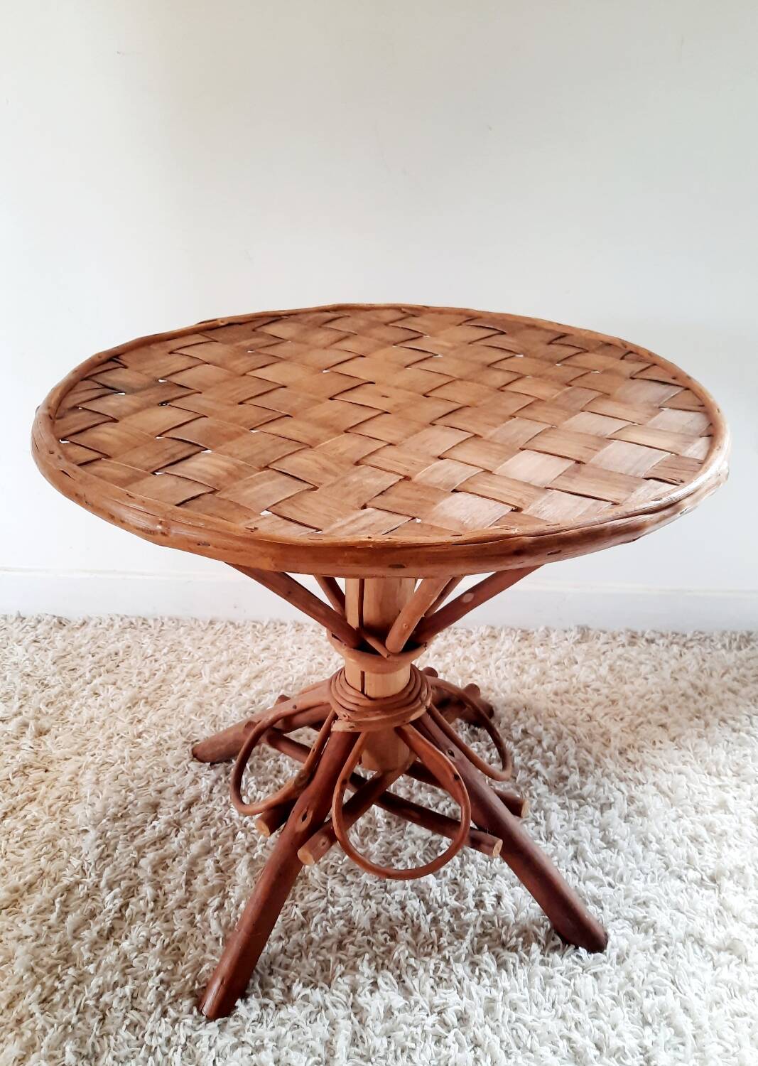 Old bamboo/rattan table with woven palm leaves.