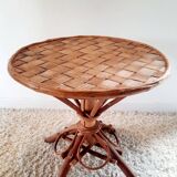 Old bamboo/rattan table with woven palm leaves.