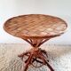 Old bamboo/rattan table with woven palm leaves.