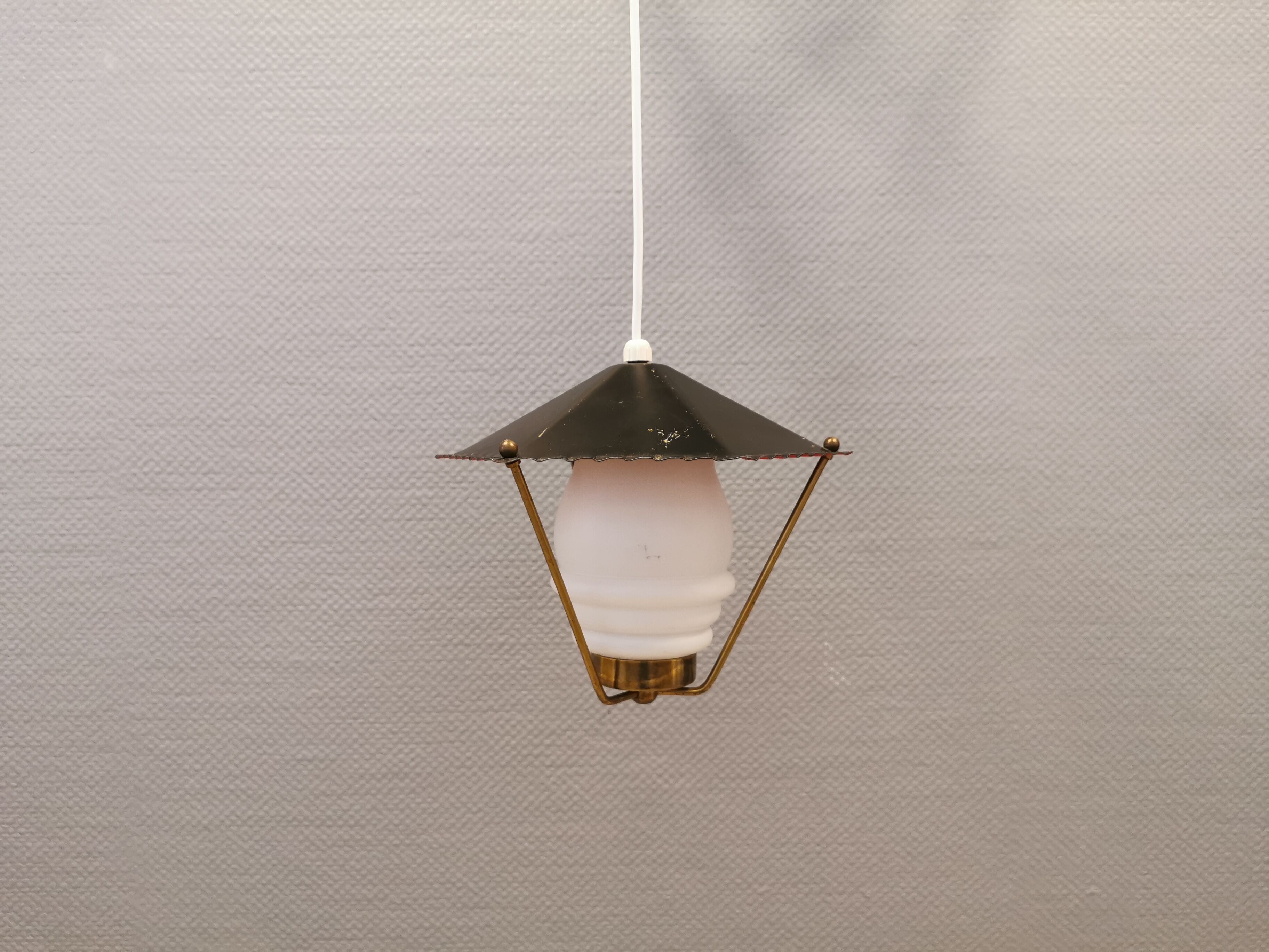 Danish hanging lamp from the 50-60s, made of brass, metal and with milky white glass shade.