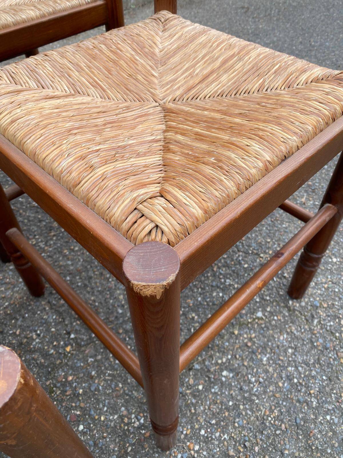 4 dining or kitchen chairs made of solid wood with rush seats.