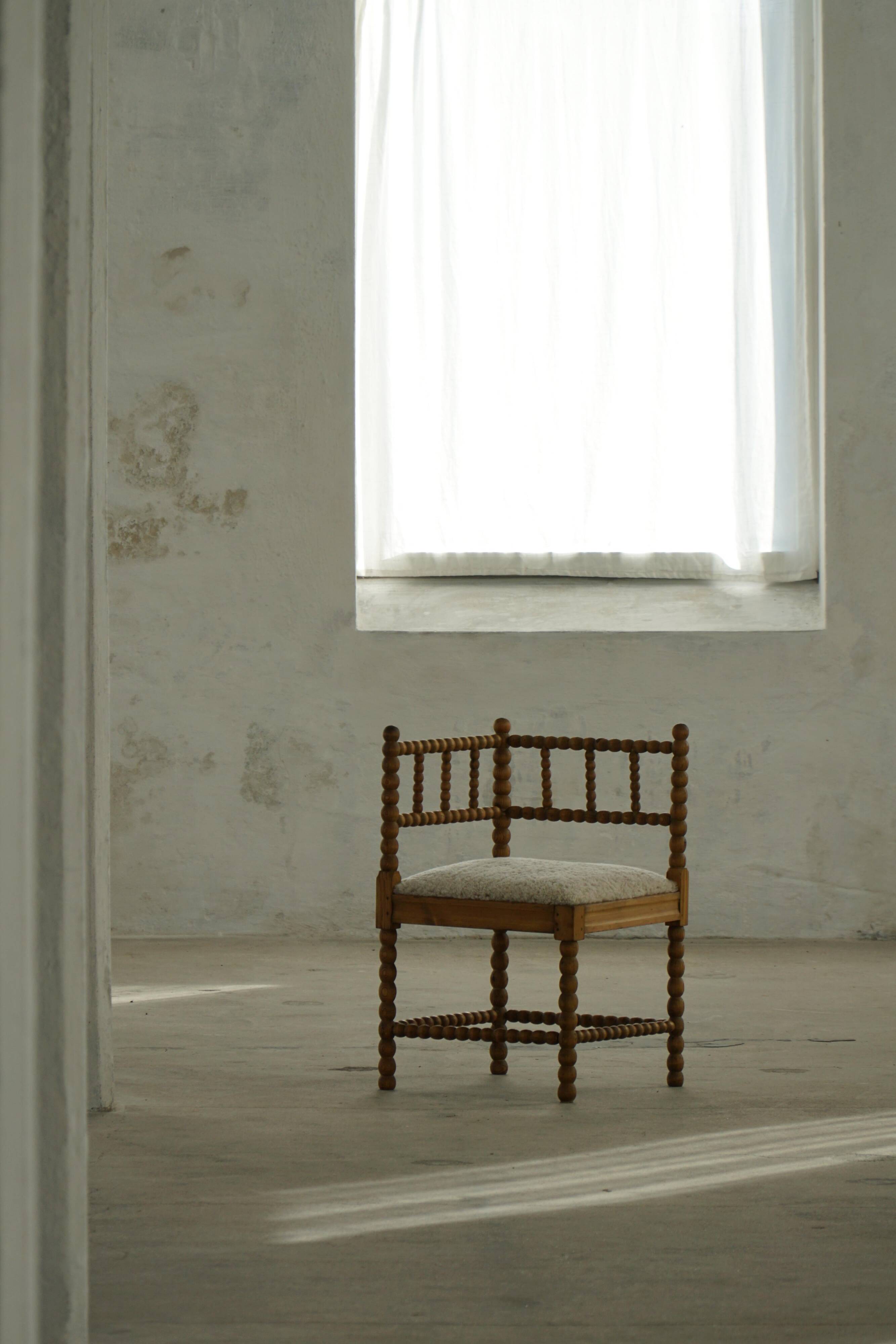 Antique French corner chair handcrafted with lamb's wool, early 20th century.
