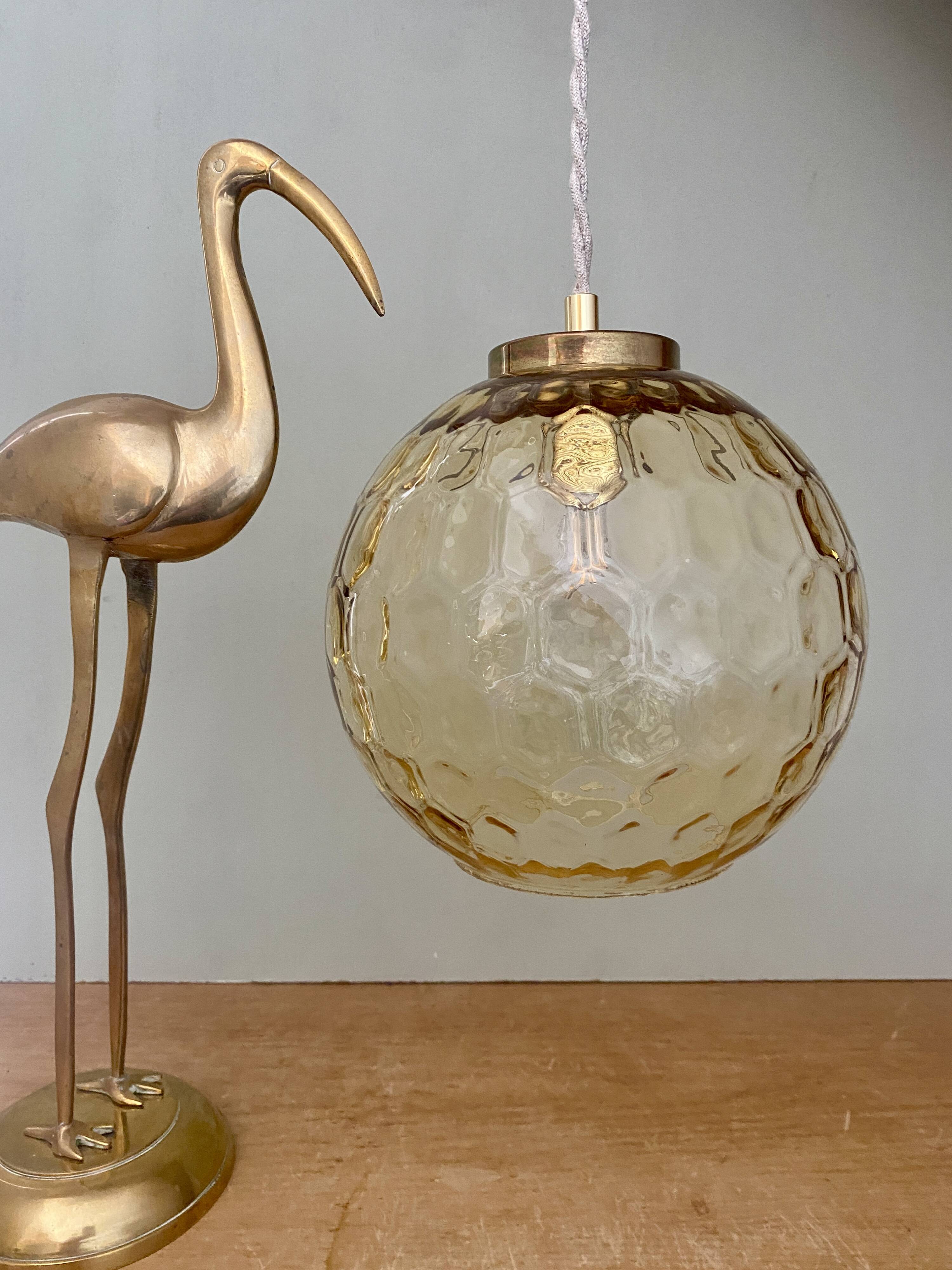 Vintage globe pendant light in amber glass