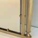 Neoclassical style mirror in brass and lacquered sheet metal.