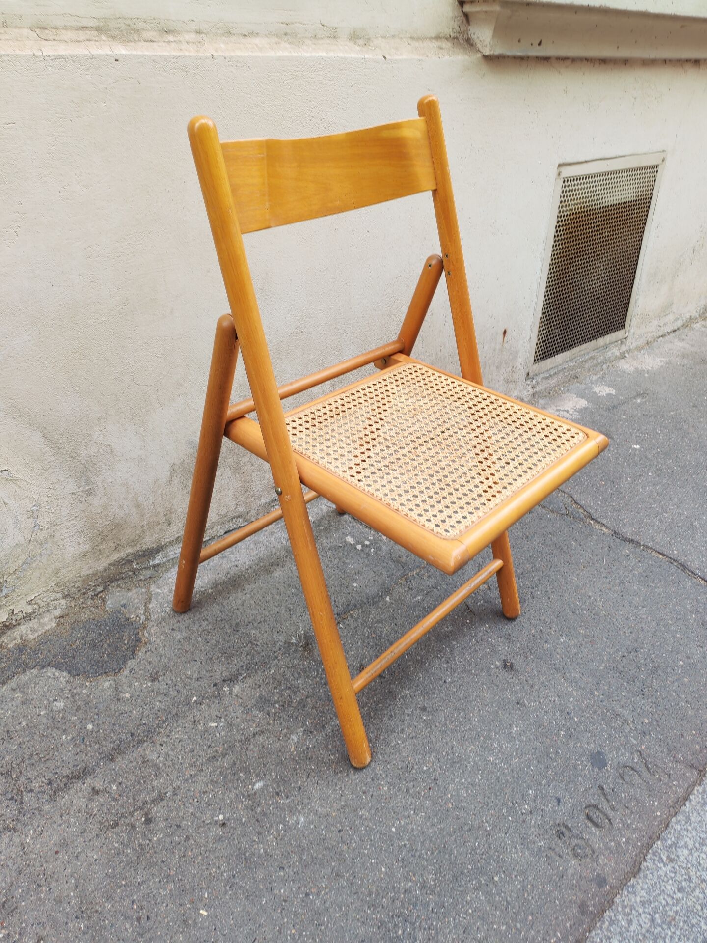 Wooden folding chair with caning from the 1980s.
