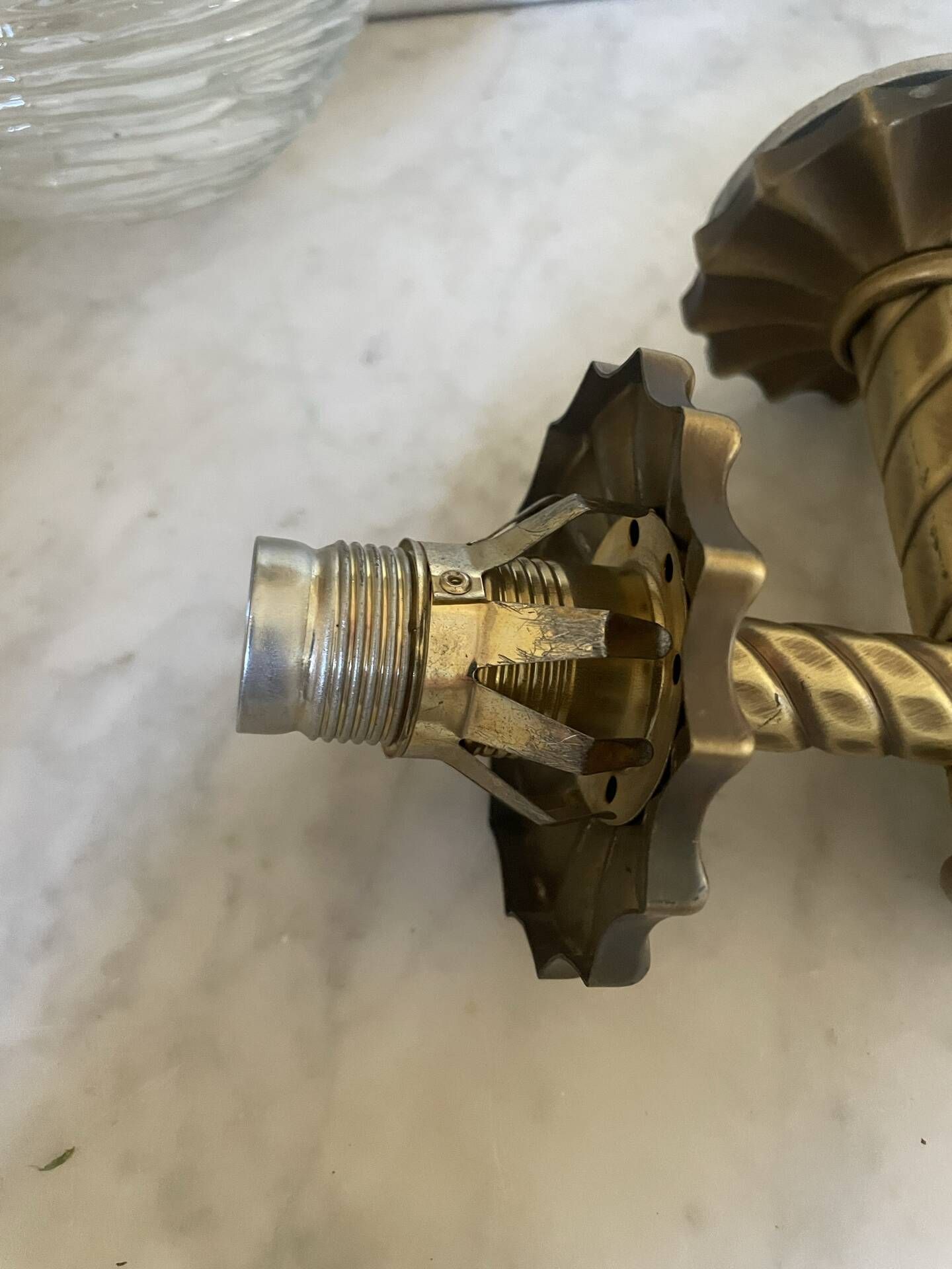 Pair of neoclassical wall sconces in twisted brass and ribbed glass.