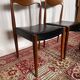 Pair of vintage teak chairs with black faux leather – Scandinavian style