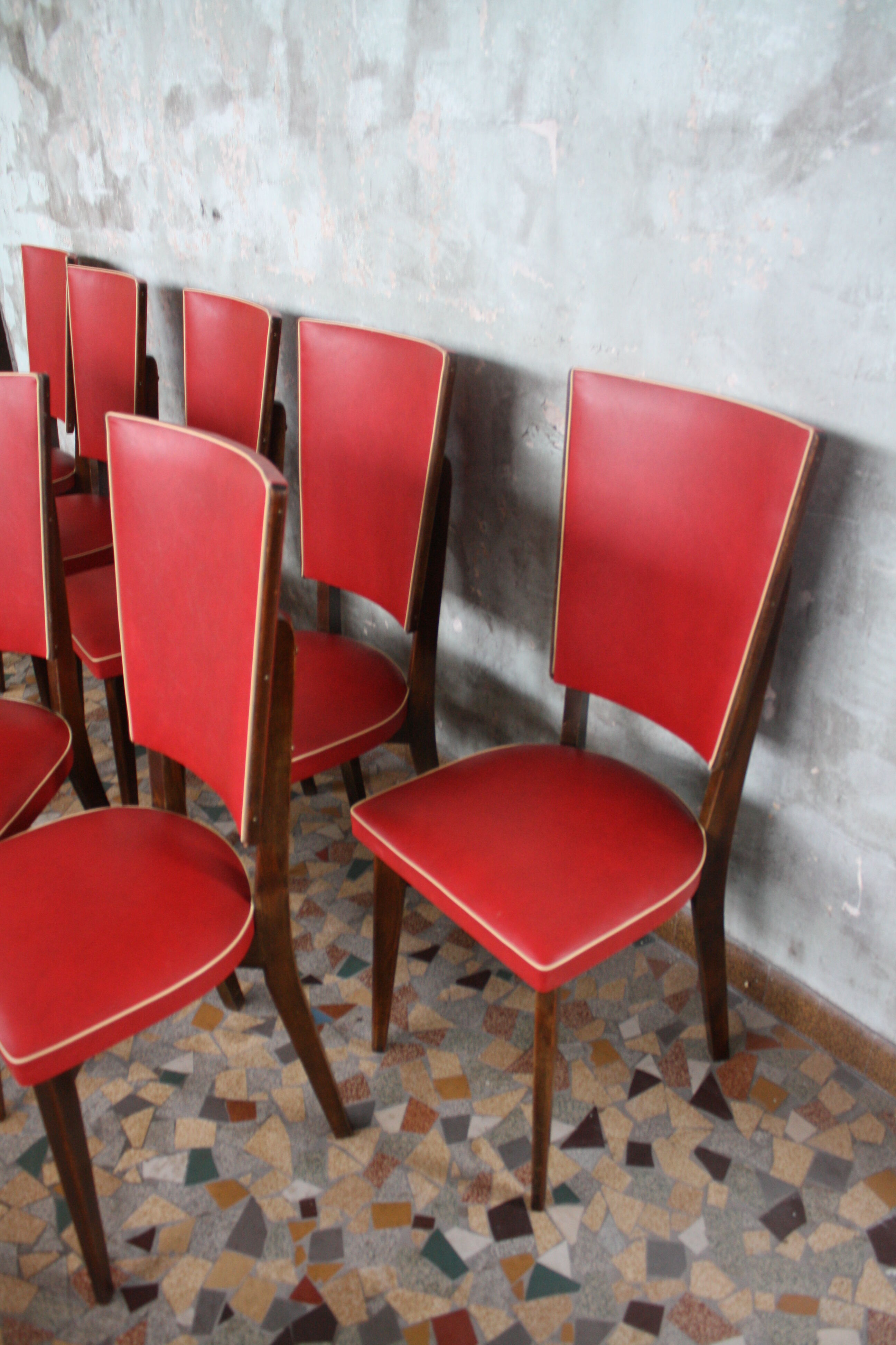 Lot of 8 vintage wooden chairs and red skai
