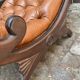 Chesterfield armchair in leather and carved solid wood
