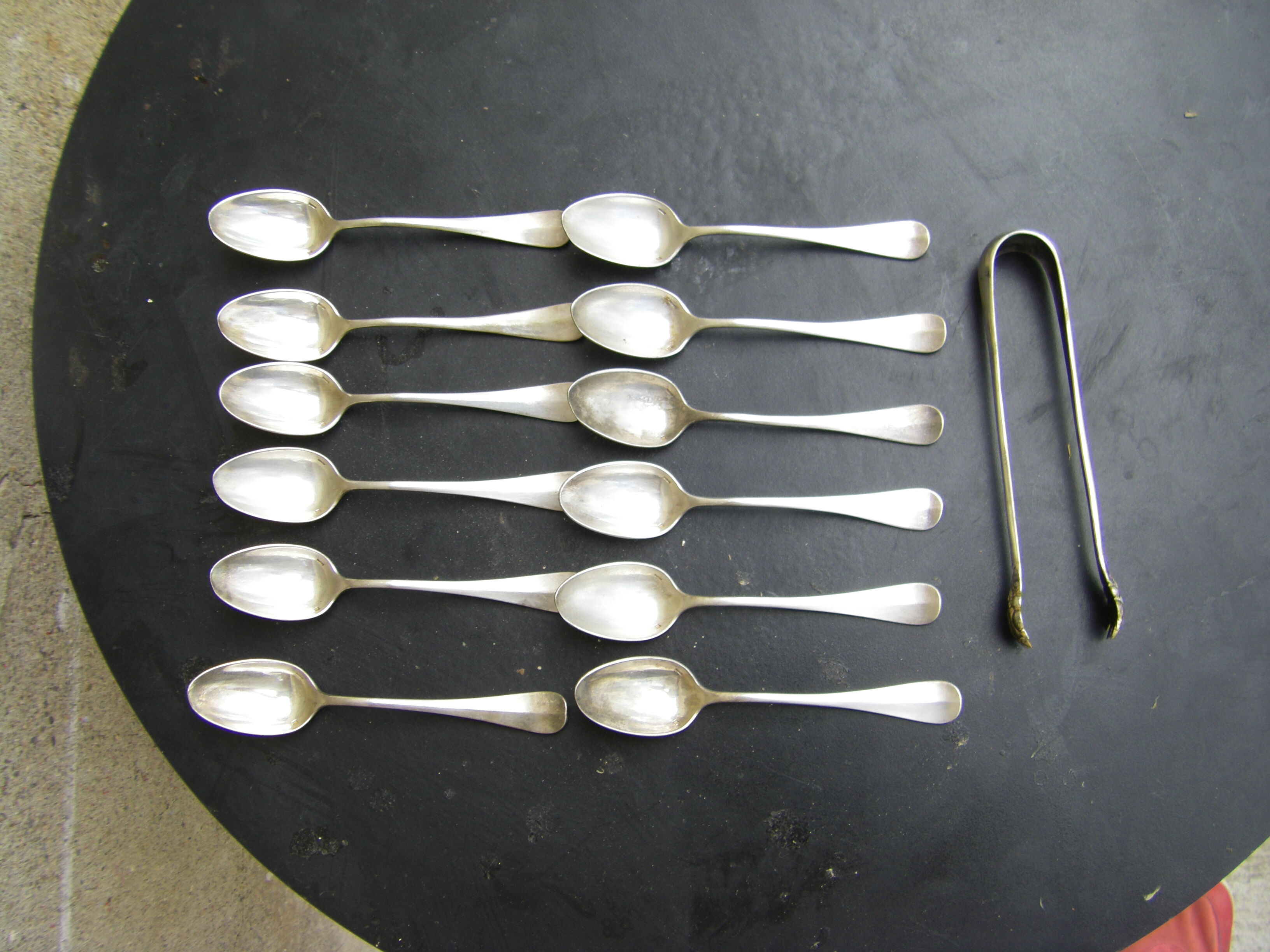 Set of twelve teaspoons and a sugar tongs