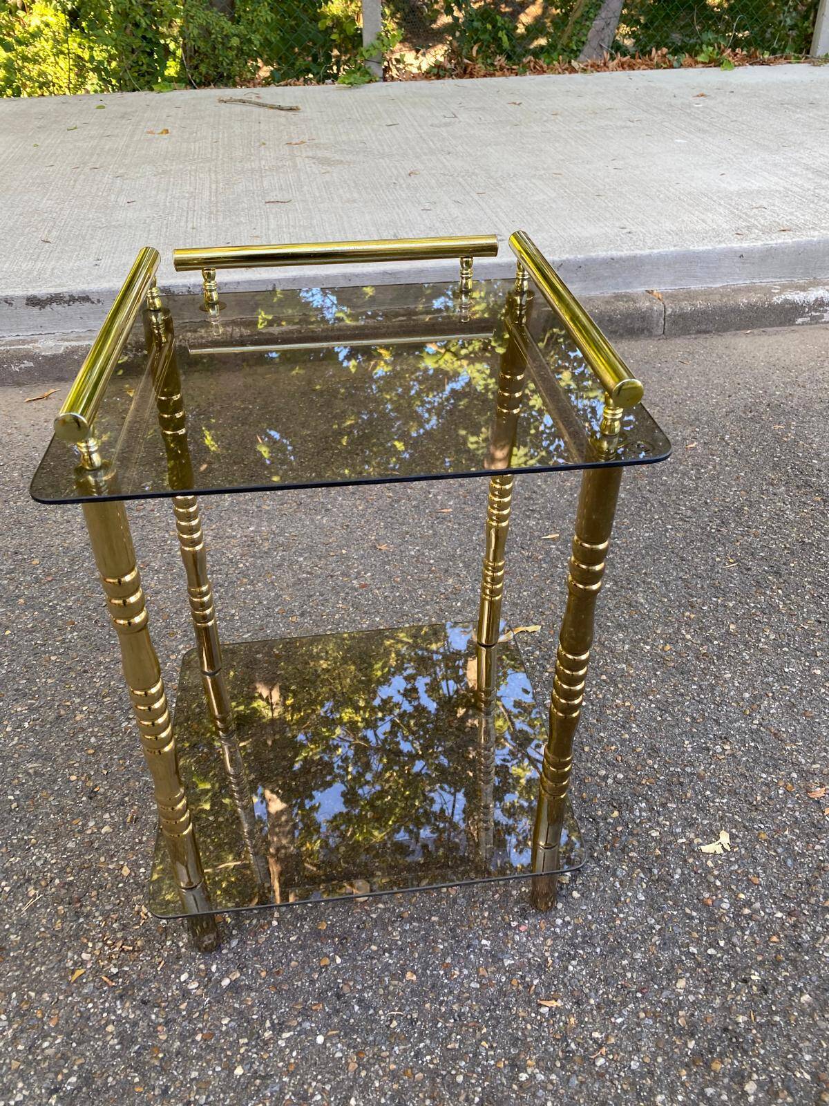 Vintage side table with smoked glass and sculpted golden brass, Hollywood Regency style.