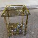 Vintage side table with smoked glass and sculpted golden brass, Hollywood Regency style.