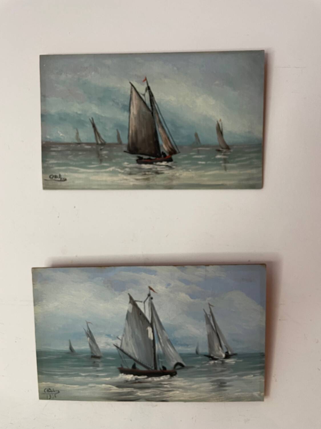 A pair of old paintings on wood.