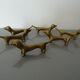 Series of 6 vintage gilded brass dachshund knife holders
