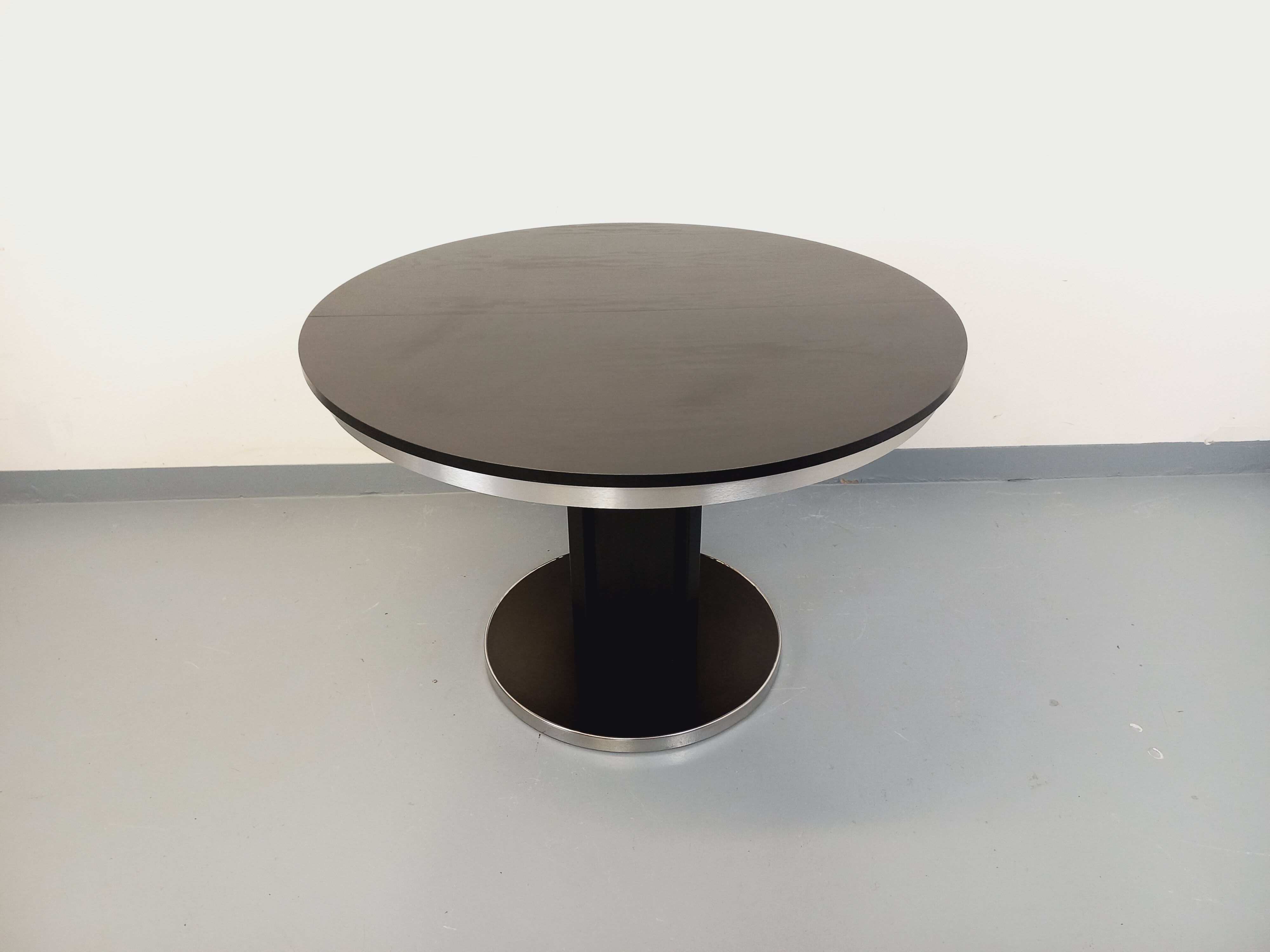 Vintage dining table in melamine with a black wood effect and chrome metal.