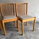 Set of 4 Scandinavian dining chairs in light wood.
