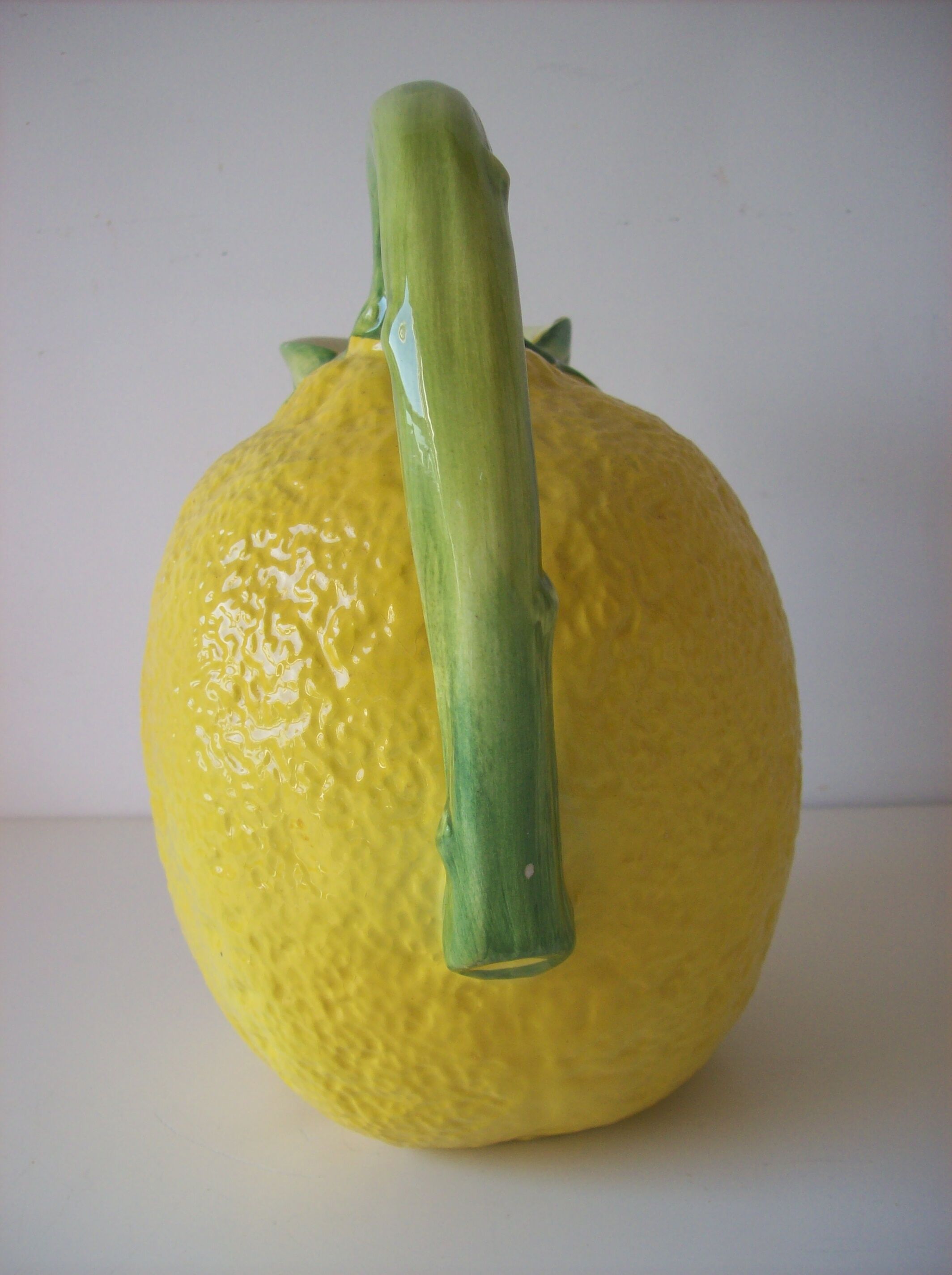 Vintage pitcher has form of lemon
