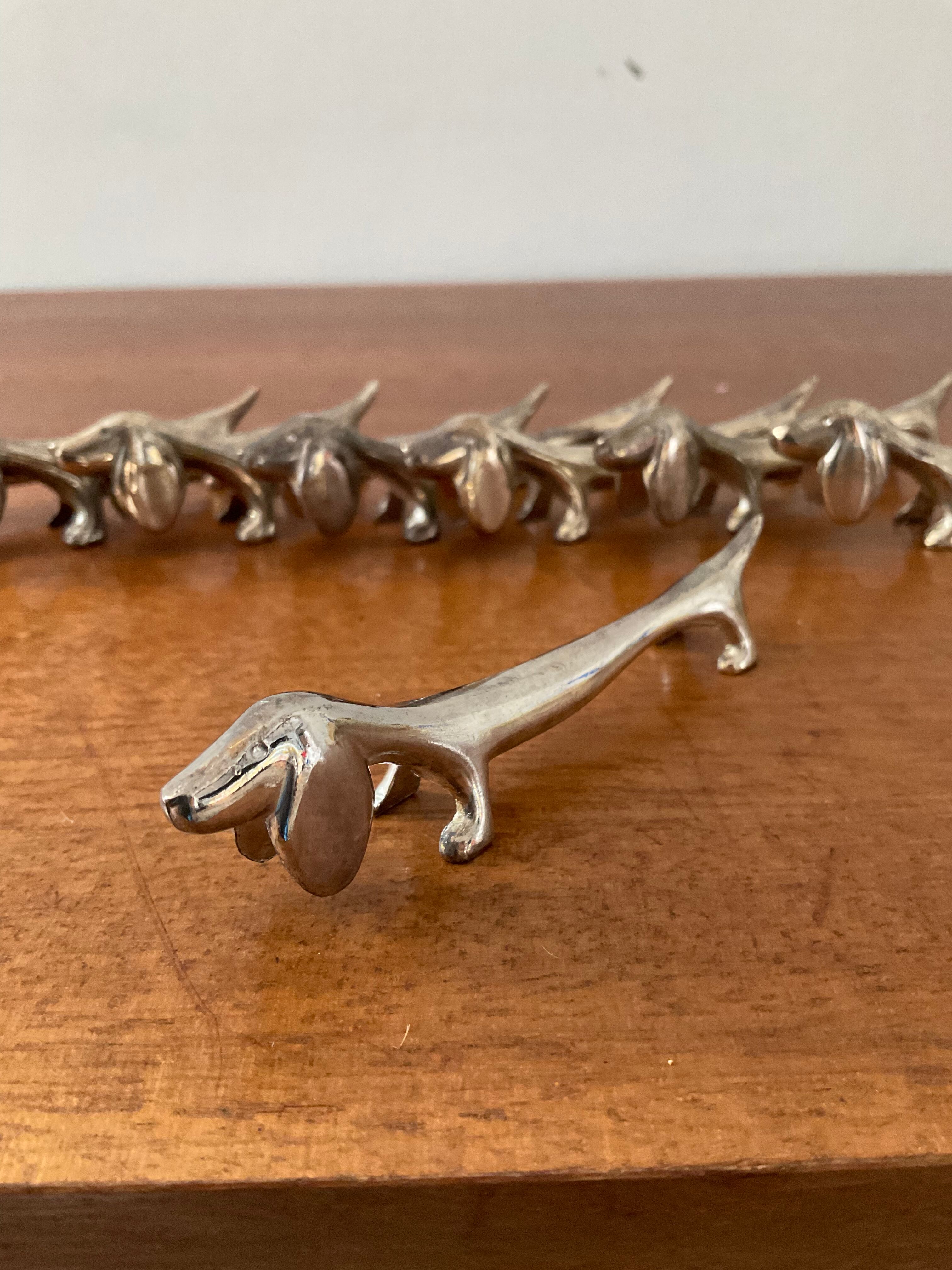 Series of 8 vintage Dachshund knife holders in silver metal