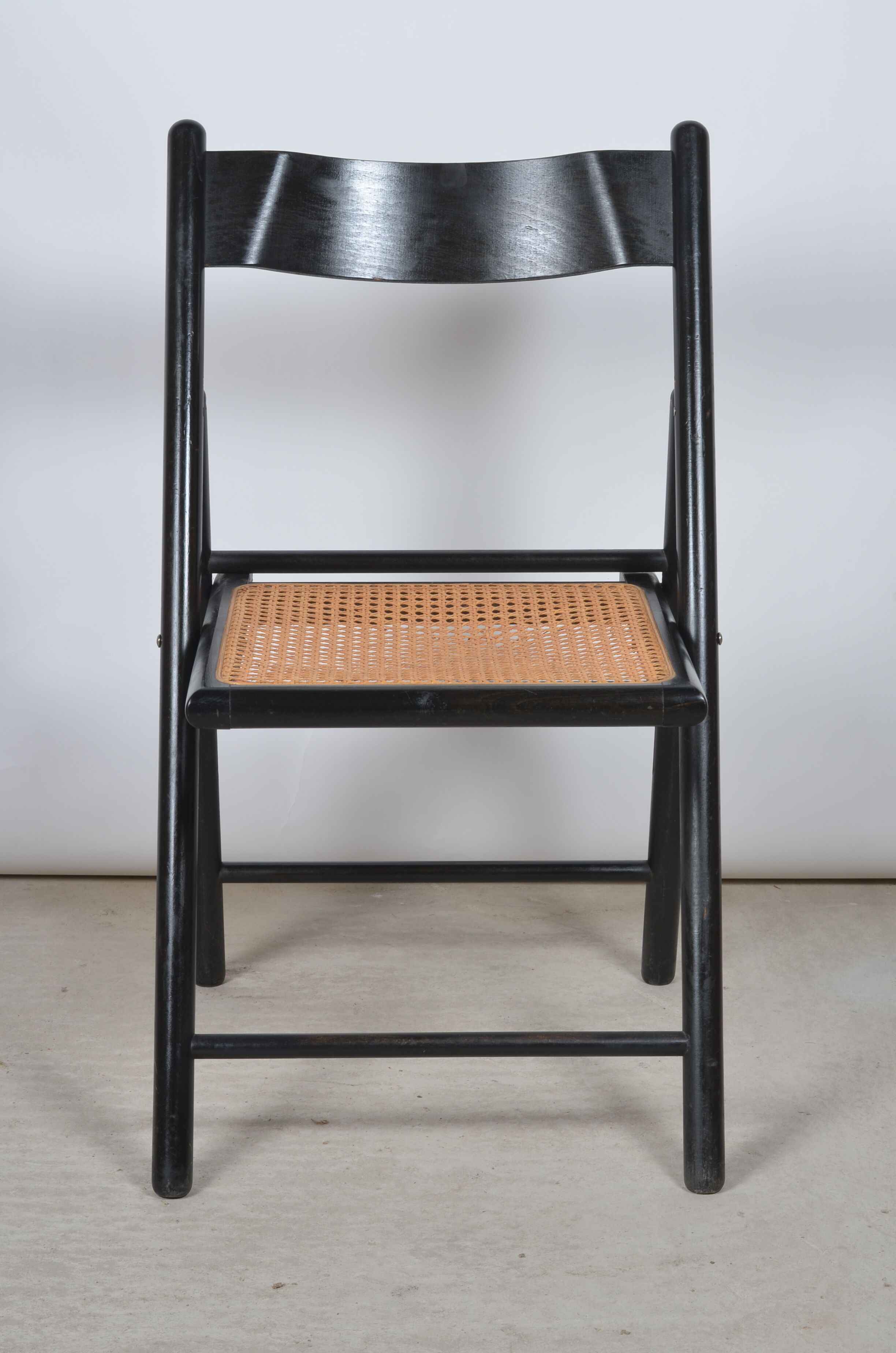 Folding chair seated in cannage