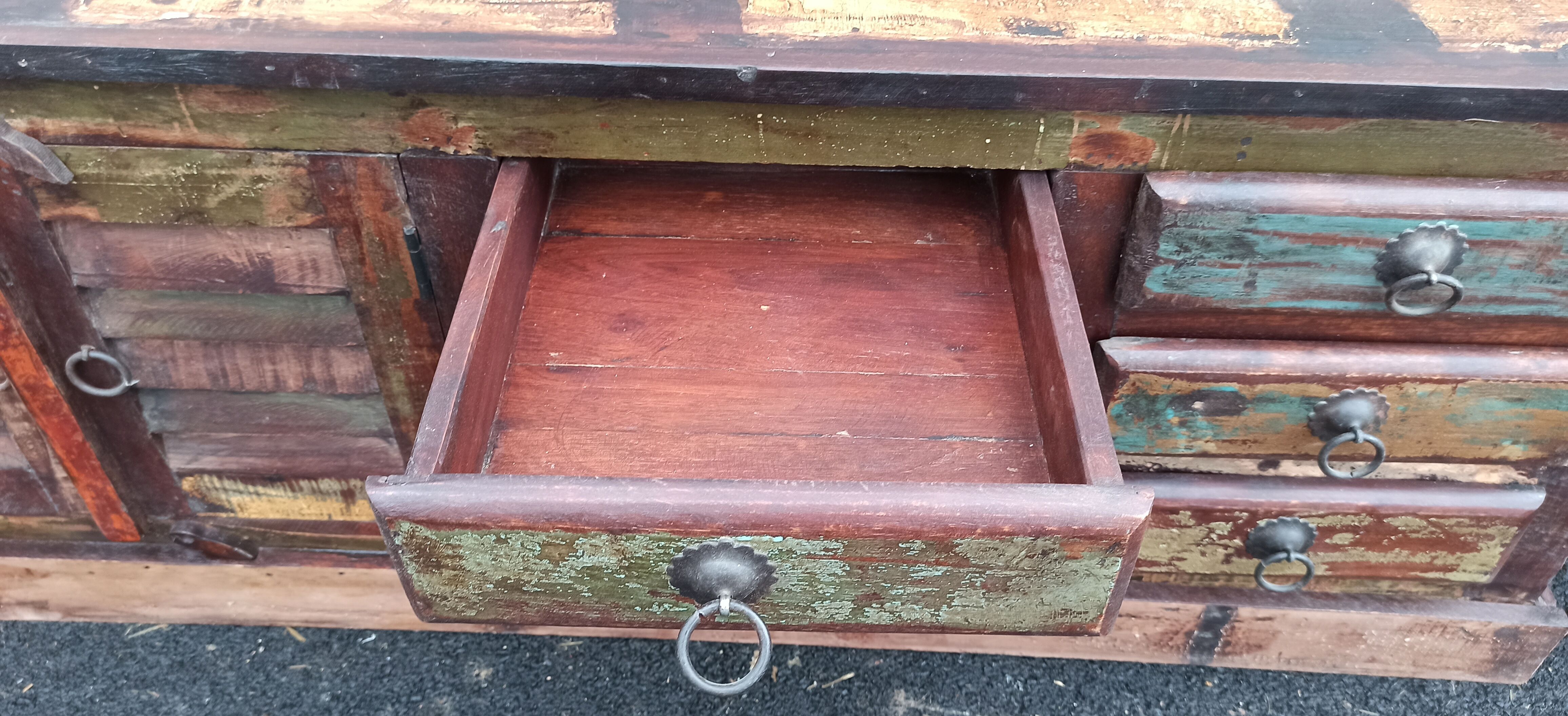 Furniture low in colorful wood. 12 drawers and 1 door