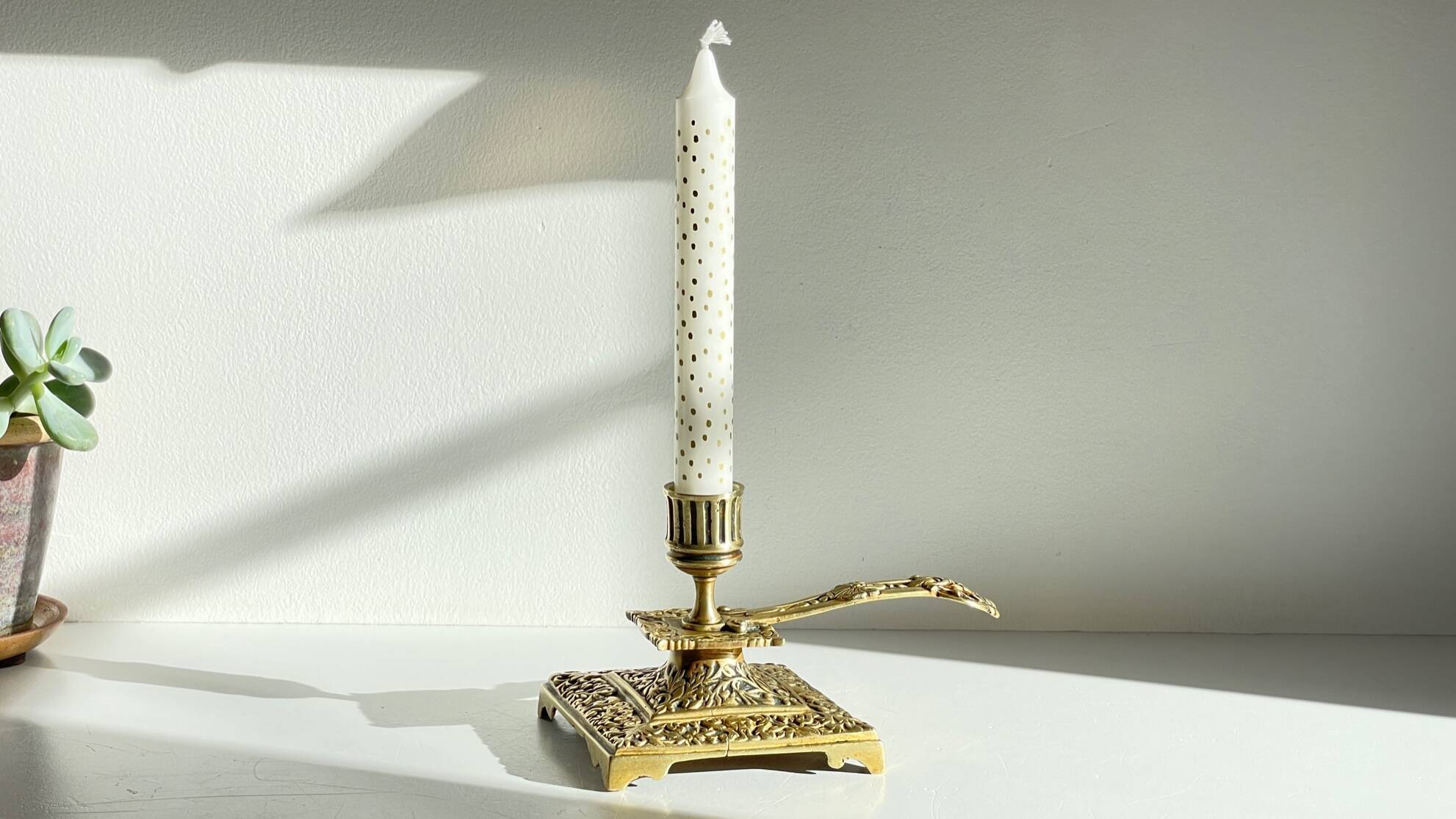 Patterned solid bronze hand candle holder