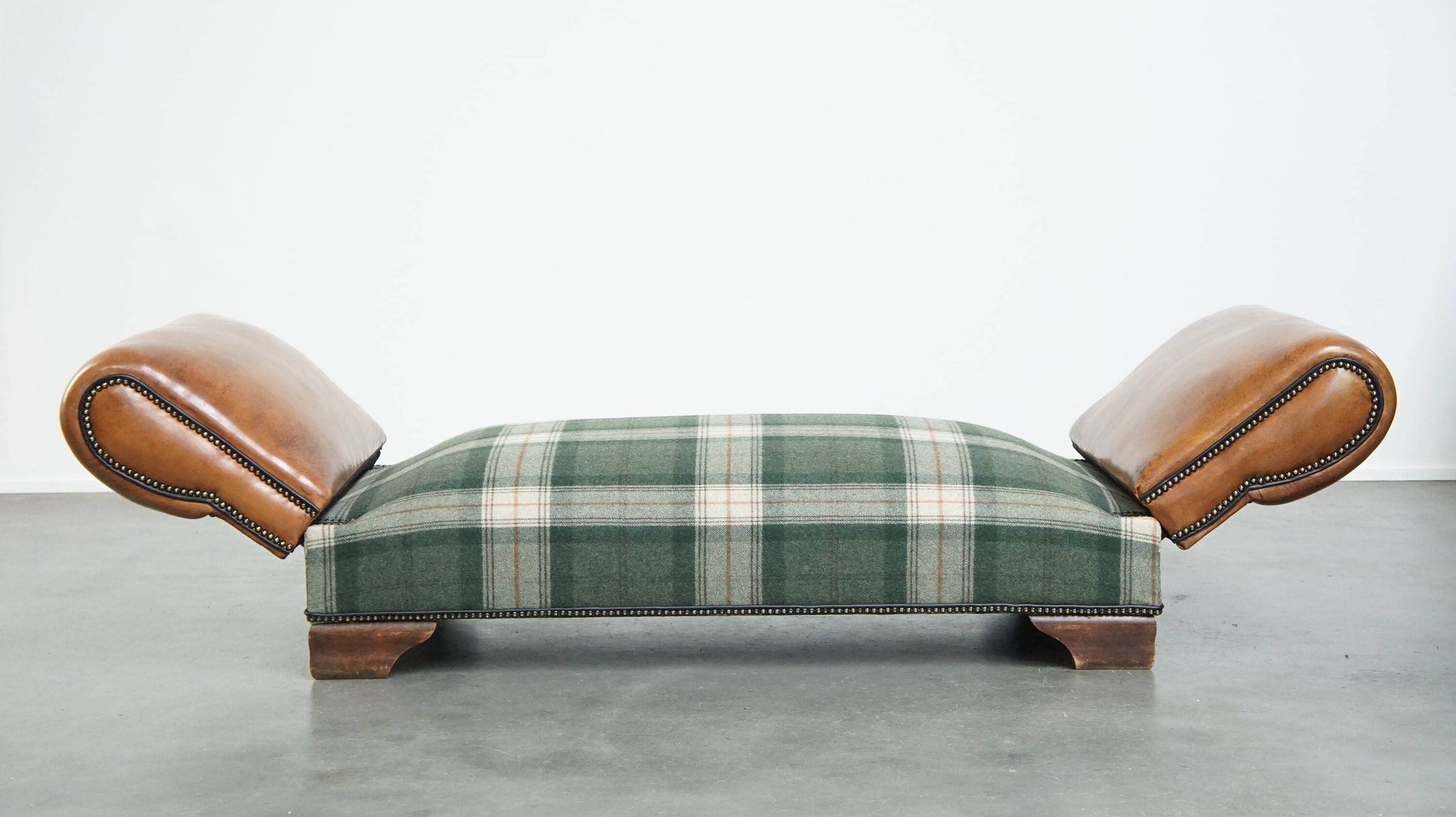 Antique daybed reupholstered with sheepskin and Scottish tartan wool