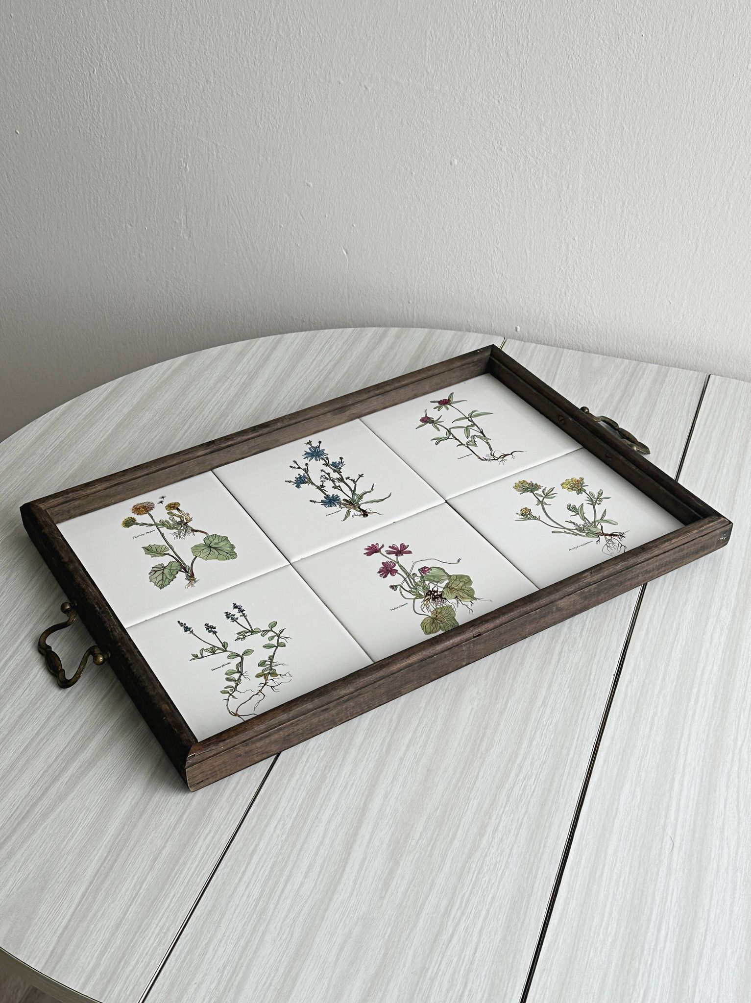 Old wooden plateau with floral tiles