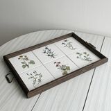 Old wooden plateau with floral tiles