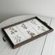 Old wooden plateau with floral tiles
