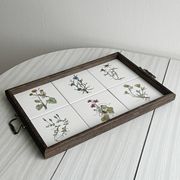 Old wooden plateau with floral tiles