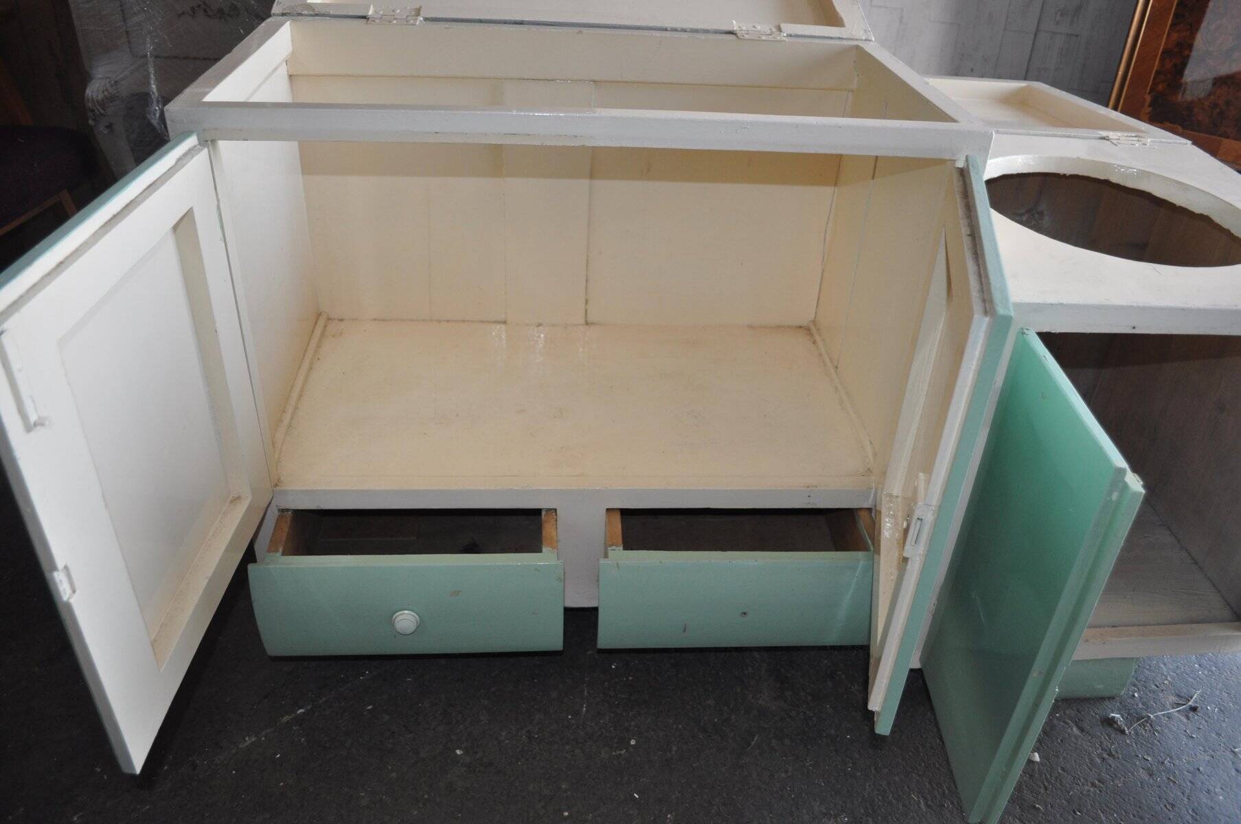Art Deco washbasin furniture in green and white wood with a glass top, storage from the 1930s.