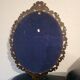 Italian oval frame in bronze and curved glass