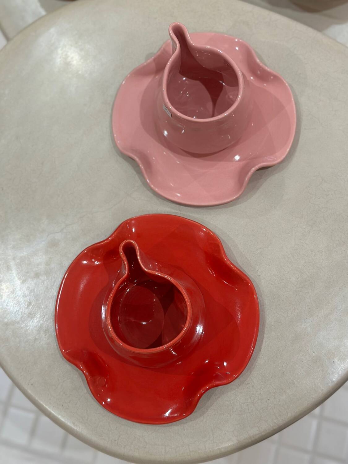 Set of ceramic artisan mugs with poppy red water lily design.