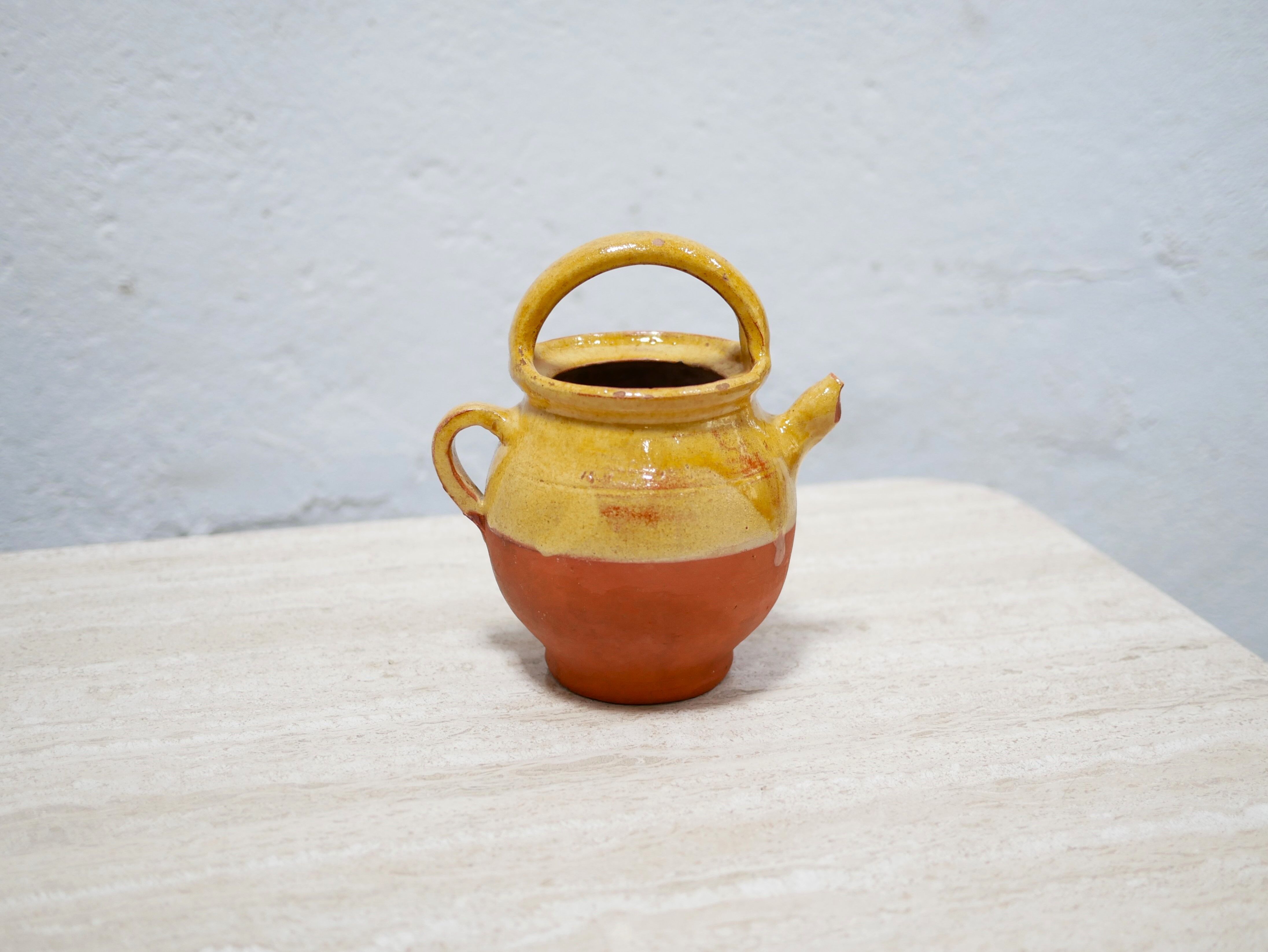 Old gargoulette pot in glazed terracotta