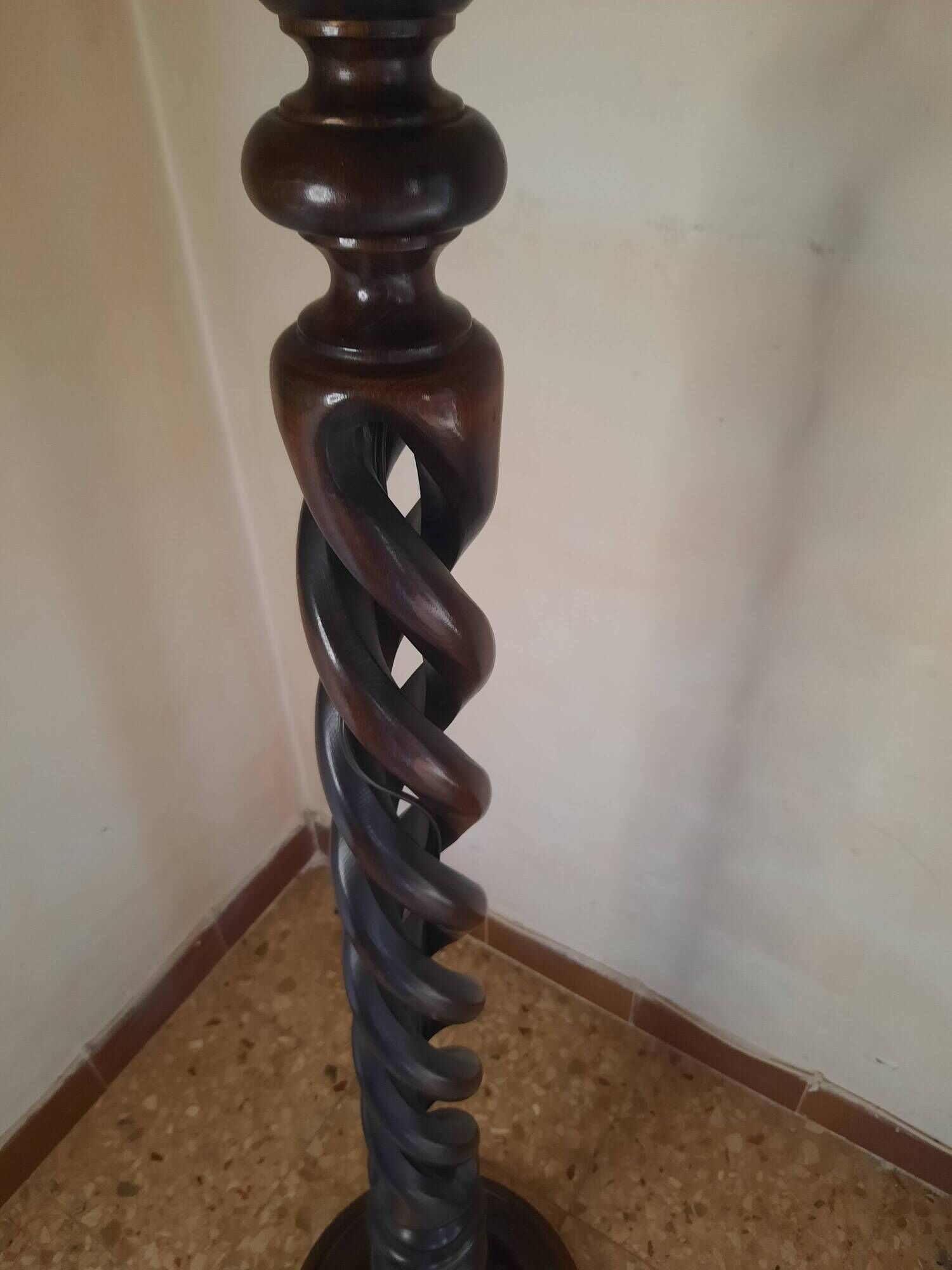 Sculptural floor lamp made of twisted turned wood.