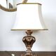 Florentine lamp in carved wood, gold leaf, silk shade.
