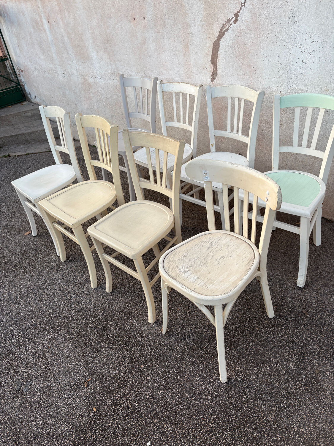 Set of 8 mismatched white bistro chairs