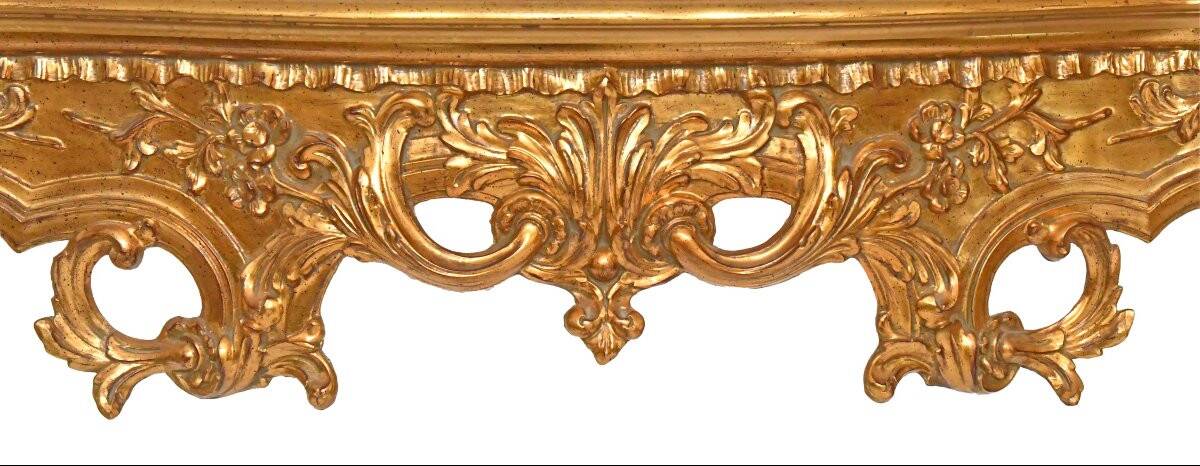 Console with a gilded wood mirror in Rococo style.