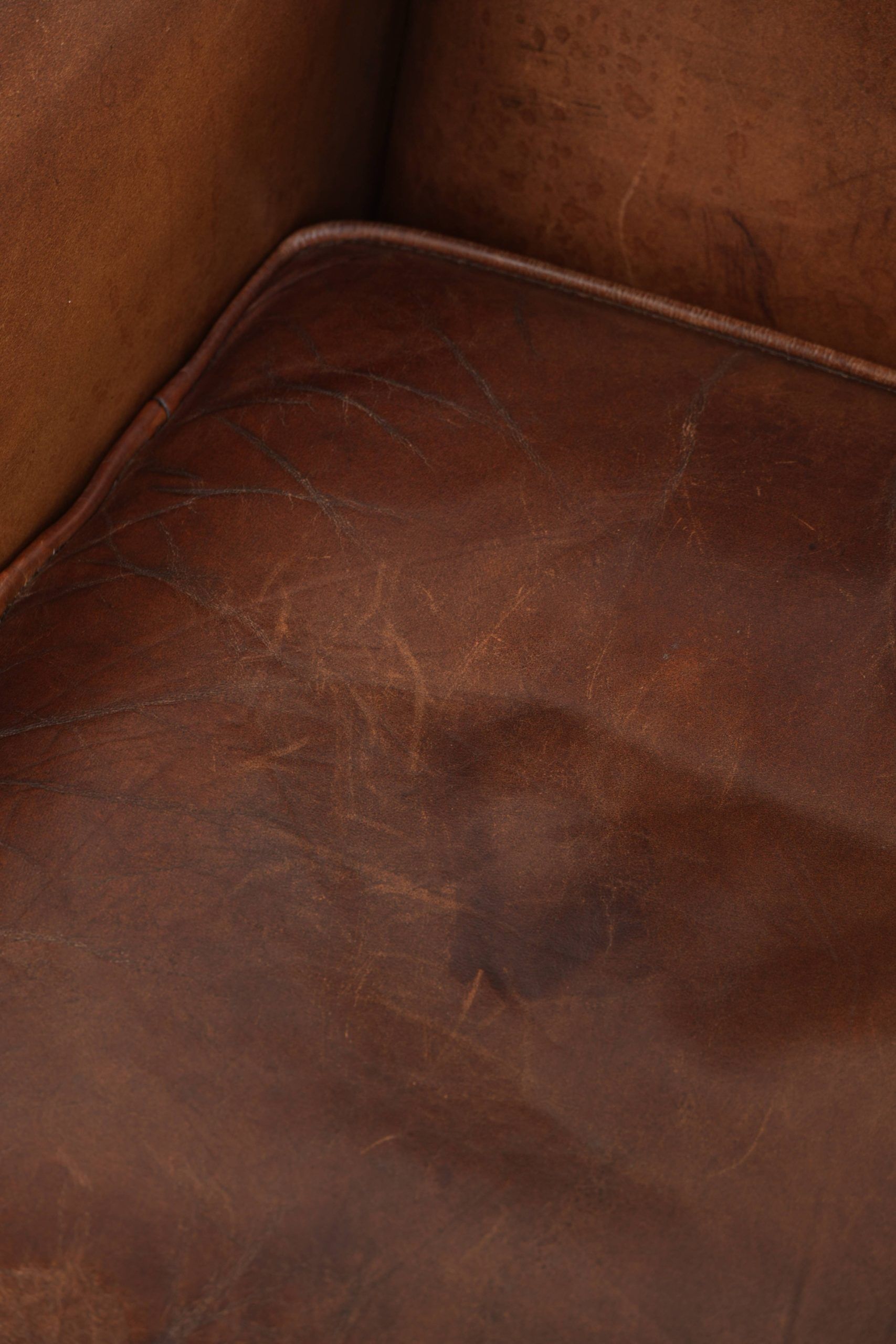 Subtle dark brown sheepskin wingback armchair with a timeless look subtle