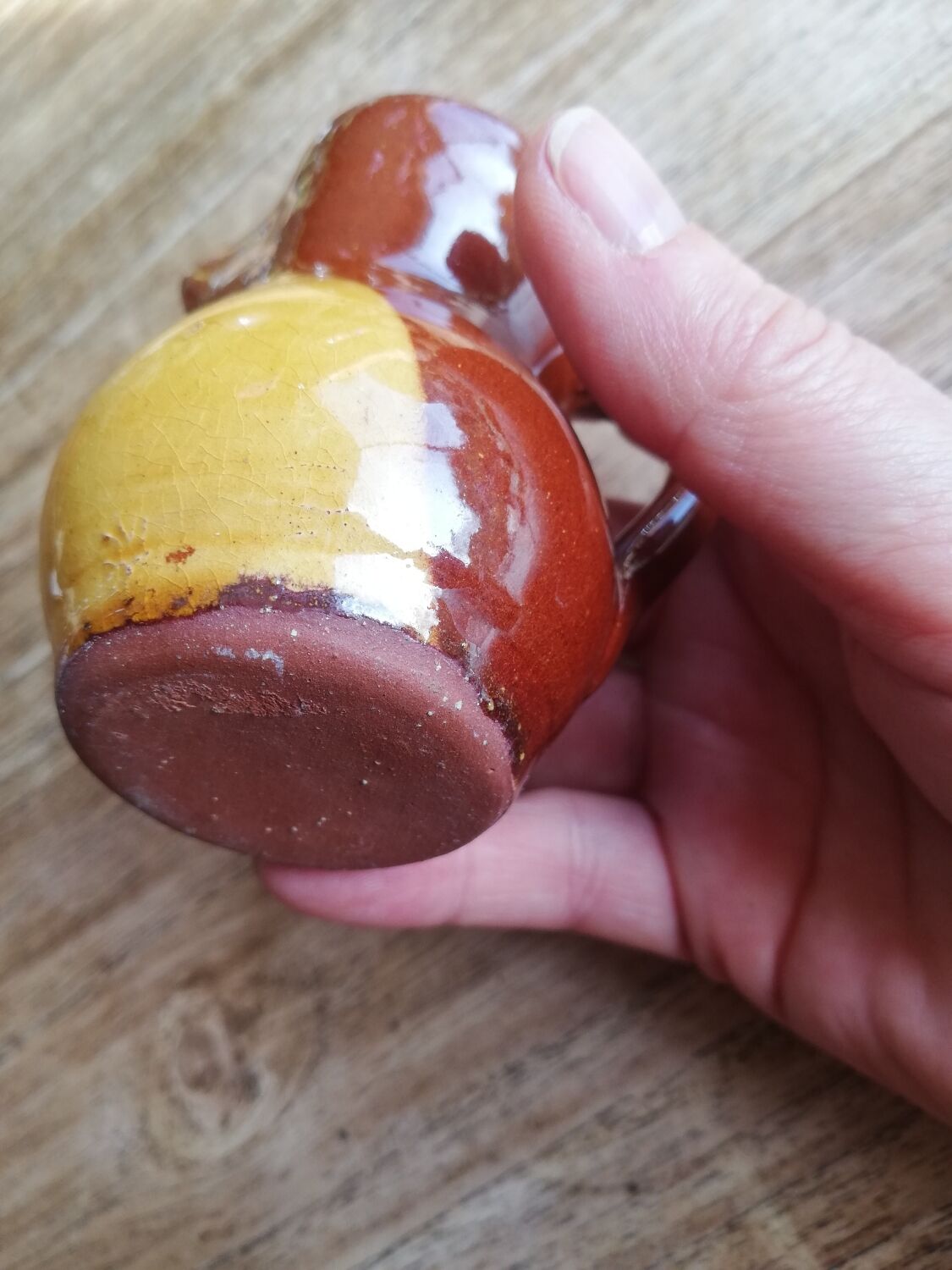 Small two-tone brown-yellow terracotta pitcher