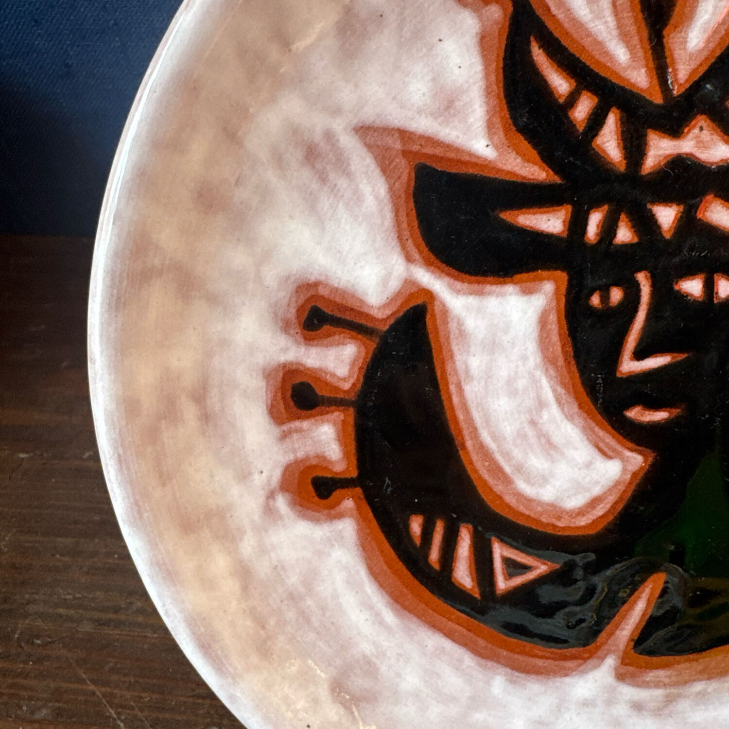 Terracotta plate, Jean Lurçat decorated with a character on a white background.