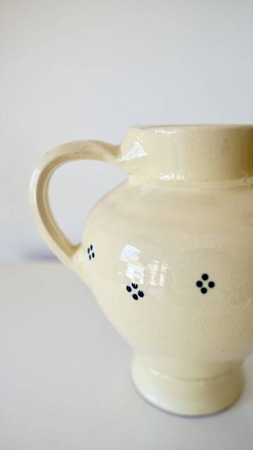 Vintage butter yellow ceramic pitcher in rustic style