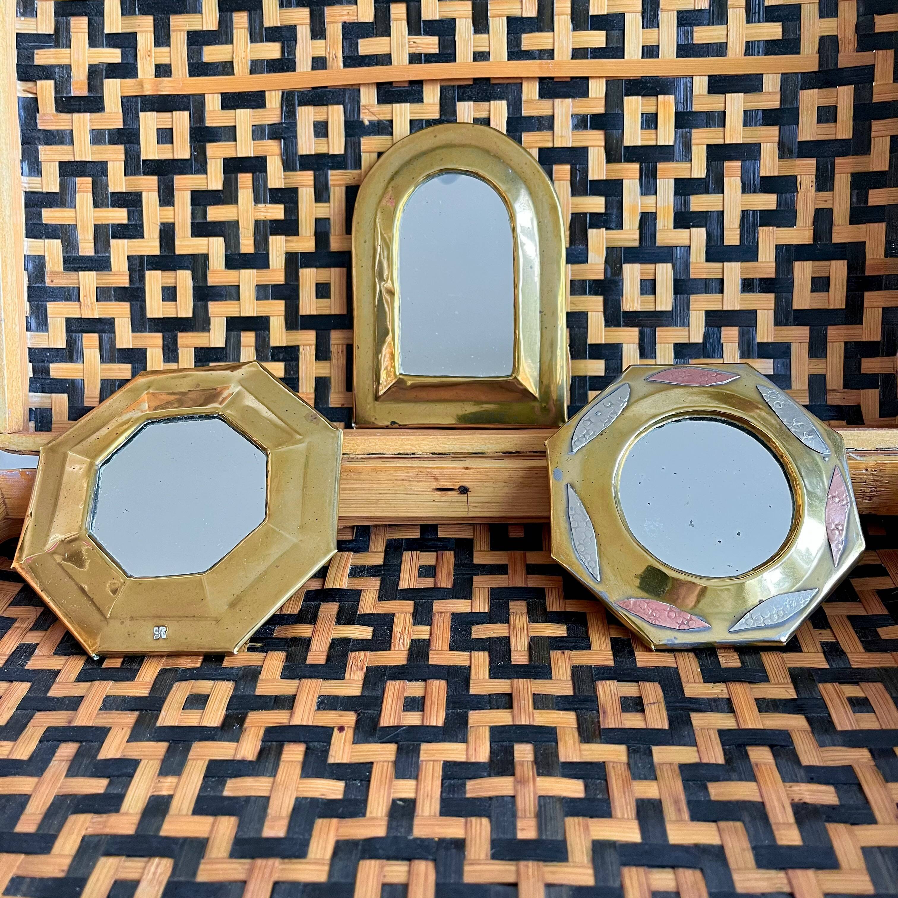 Trio of small brass mirrors