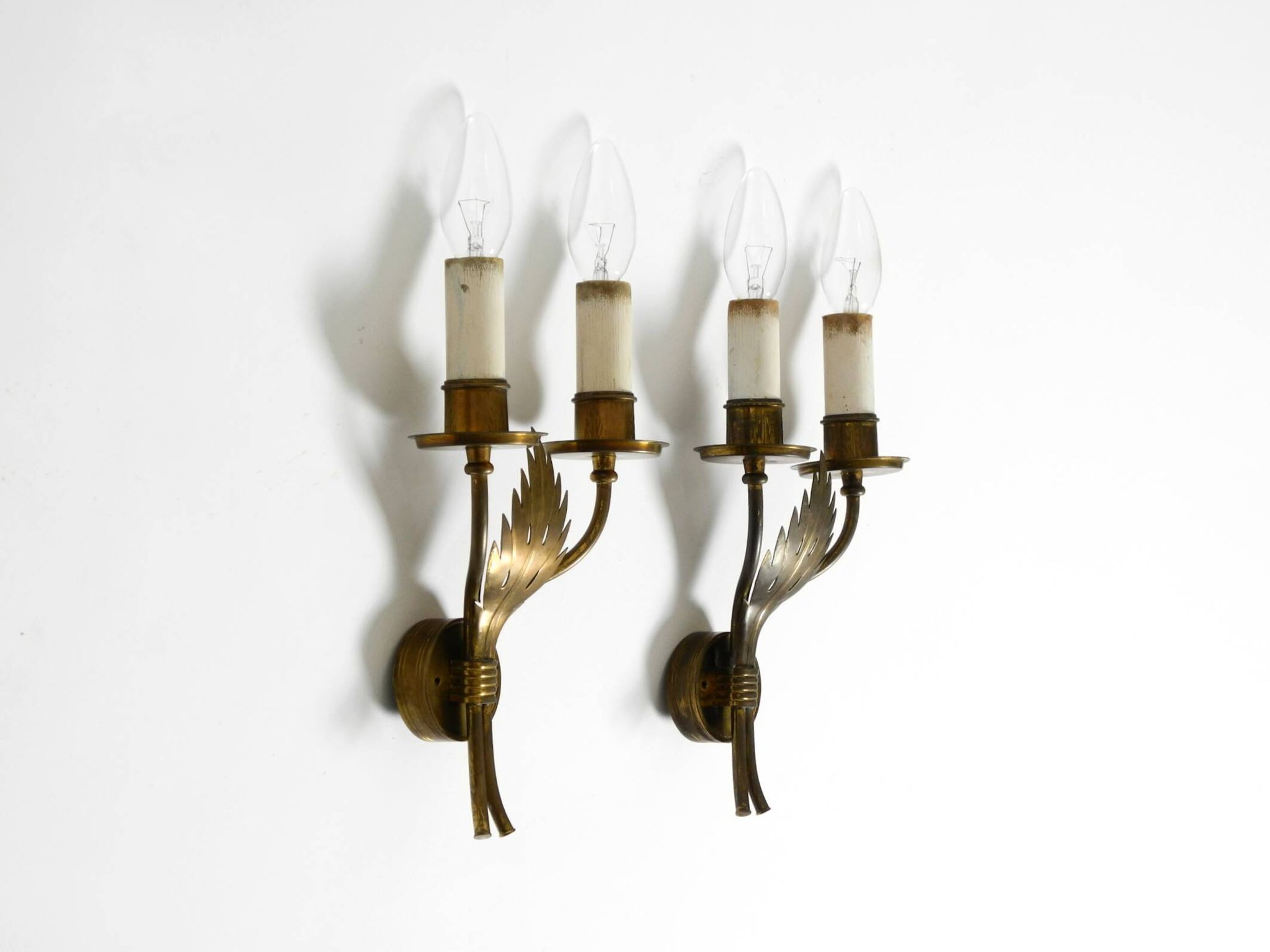 A pair of mid-century modern brass wall lamps by Vereinigte Werkstätten