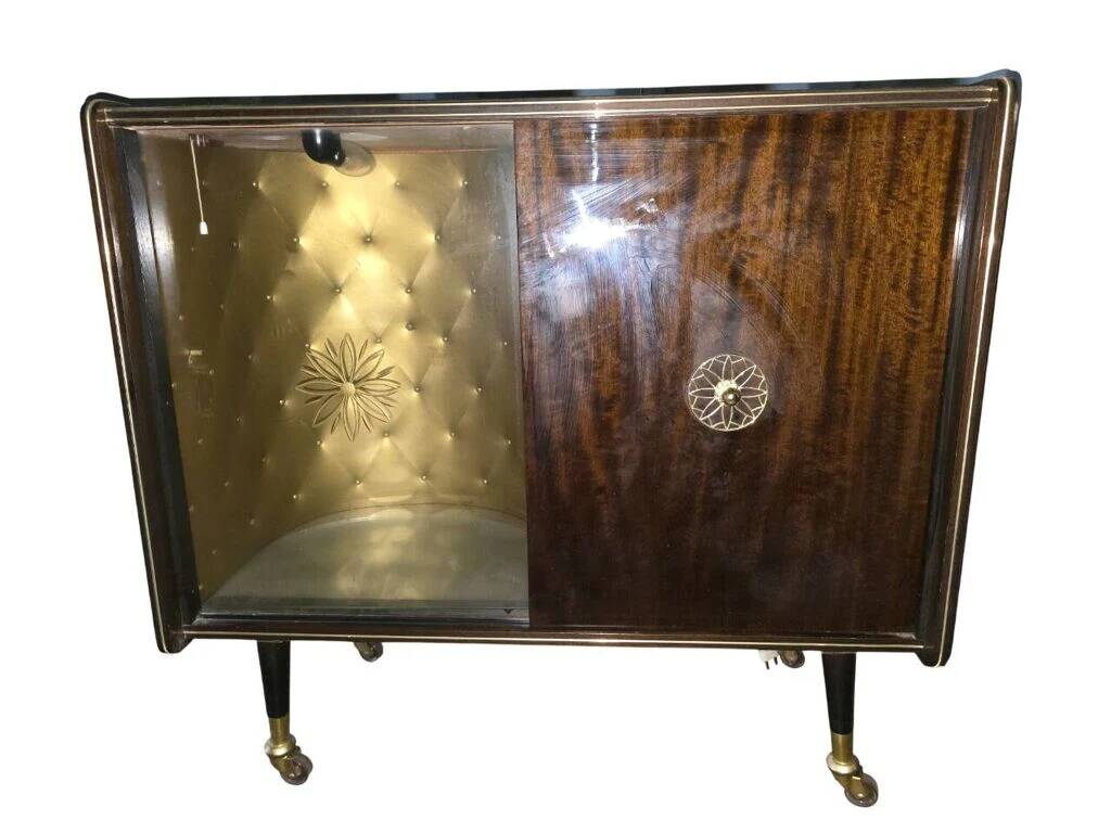 Vintage 50s-60s bar cabinet with tufted upholstery and lighting.