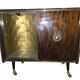 Vintage 50s-60s bar cabinet with tufted upholstery and lighting.