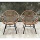Pair of rattan shell chairs with metallic feet
