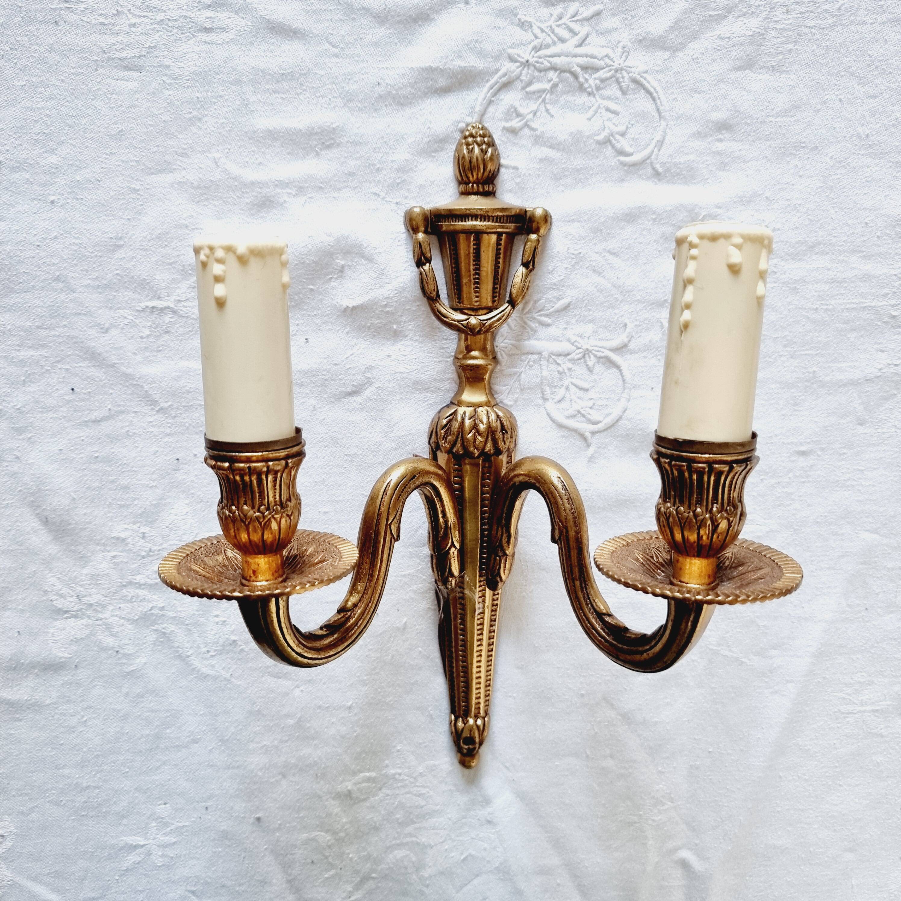 French Empire-style wall sconce or chandelier in bronze with an antique gold patina.