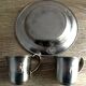 2 plates and 2 silver-plated metal cups by Gero Zilmeta with rabbit designs.